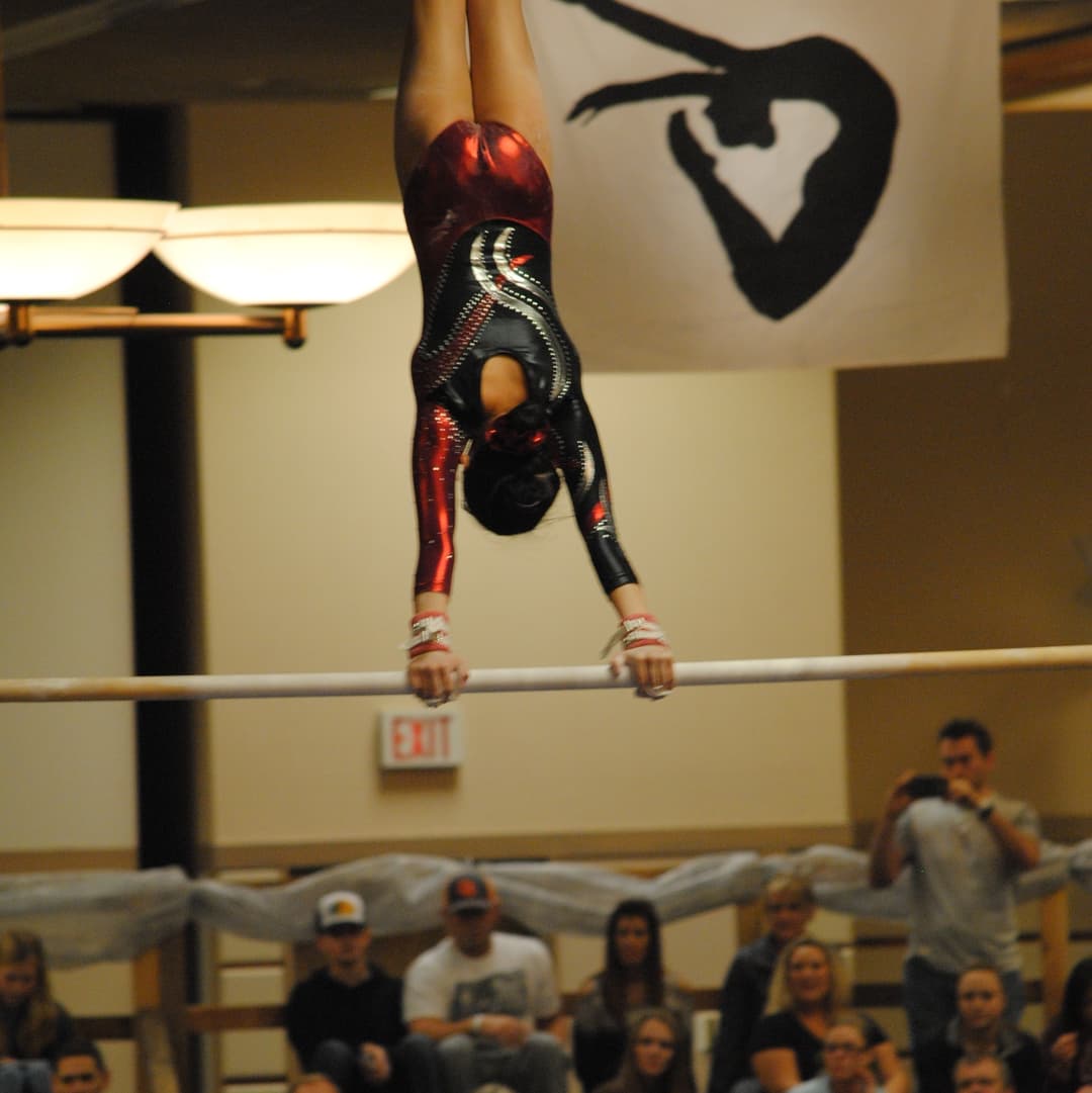 picture of evelynn doing a giant on the gymnastics uneven bars